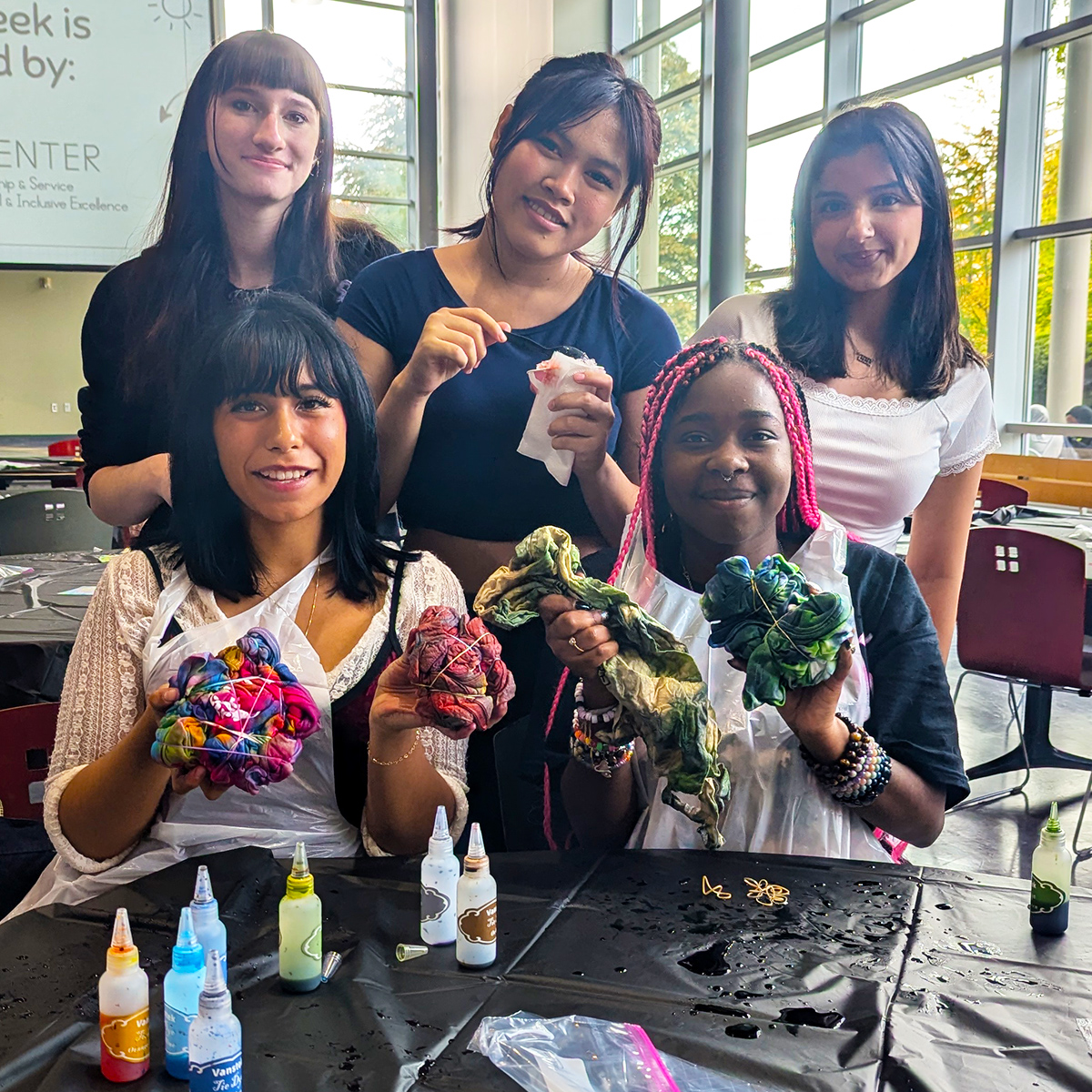 Students showcasing their tie-dye shirts during Fall 2024 Thunderweek.
